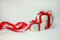 Christmas Gift in White Box with Red Ribbon on Light Background. New Year Holiday Composition. Copy Space Royalty Free Stock Photo