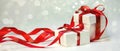 Christmas Gift in White Box with Red Ribbon on Light Background. New Year Holiday Composition. Copy Space Royalty Free Stock Photo