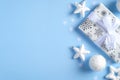 Christmas gift, white decorations, stars, balls on blue background. Flat lay, top view. Christmas, New year, winter holidays Royalty Free Stock Photo