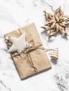 Christmas gift wrapped in craft paper with homemade Christmas decorations on a light background, top view Royalty Free Stock Photo