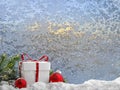 Christmas gifts on the background frosty patterns on the window. Nature draws.