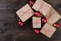 Christmas gifts box presents with red balls on wooden background Royalty Free Stock Photo