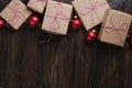 Christmas gifts box presents with red balls on wooden background Royalty Free Stock Photo