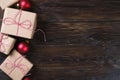 Christmas gifts box presents with red balls on wooden background Royalty Free Stock Photo