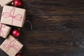 Christmas gifts box presents with red balls on wooden background top view text space Royalty Free Stock Photo