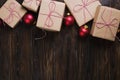 Christmas gifts box presents with red balls on wooden background top view text space Royalty Free Stock Photo