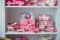 Christmas gifts in box on a shelf, pink car, airplane, wooden horse and gingle bell. Royalty Free Stock Photo