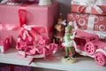 Christmas gifts in box on a shelf, pink car, airplane, wooden horse and gingle bell. Royalty Free Stock Photo
