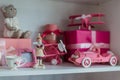 Christmas gifts in box on a shelf, pink car, airplane, wooden horse and gingle bell. Royalty Free Stock Photo