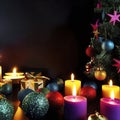 Christmas gifts, christmas tree, candles, colored decor, stars, balls on black background Royalty Free Stock Photo