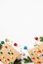 Christmas gifts with colorful balls ornaments and fir branches on white background. Christmas and New Year party invitation design Royalty Free Stock Photo