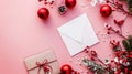 Christmas gifts concept with flowers, envelope, and red ornaments on pink background