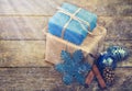 Christmas Gifts Decorated with Linen Cord, Cinnamon, Pine cones,Christmas Decoration . Toned image. Snow and Rays Drawn.