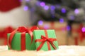 Christmas gifts on fuzzy rug against blurred background Royalty Free Stock Photo