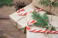 Christmas gifts or gift box wrapped in kraft paper with decorations, pine cones and fir branches on a rustic wooden Royalty Free Stock Photo