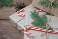 Christmas gifts or gift box wrapped in kraft paper with decorations, pine cones and fir branches on a rustic wooden Royalty Free Stock Photo