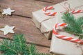 Christmas gifts or gift box wrapped in kraft paper with decorations, pine cones and fir branches on a rustic wooden Royalty Free Stock Photo
