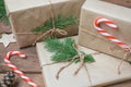 Christmas gifts or gift box wrapped in kraft paper with decorations, pine cones and fir branches on a rustic wooden Royalty Free Stock Photo