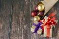 Christmas gifts, gold, silver, red Christmas balls spilled out from a package of kraft paper on a wooden background. Christmas bal Royalty Free Stock Photo