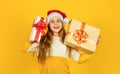 Christmas gifts for kids. Small cute girl preparing holiday gifts. Receiving presents. Kid little cheerful girl hold