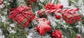 Christmas gifts and ornaments on snowy fir branch.