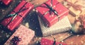 Christmas gifts packed on brown wooden table and snow fall