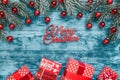 Christmas gifts presents on blue wooden background. Simple, classic gift boxes with red ribbon and holiday decorations Royalty Free Stock Photo