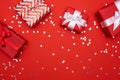 Christmas gifts presents on red background. Simple, classic red and white wrapped gift boxes with ribbon bows and festive holiday Royalty Free Stock Photo