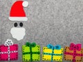 Christmas gifts and Santa Claus on grey background. Royalty Free Stock Photo