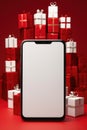 Christmas gifts and smartphone with blank space for text on red background, christmas gifts concept, shopping . Royalty Free Stock Photo