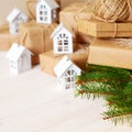 Christmas gifts with snowflakes. Small white houses. Walnuts. Royalty Free Stock Photo