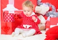 Christmas gifts for toddler. Things to do with toddlers at christmas. Little baby girl play near pile of gift boxes Royalty Free Stock Photo