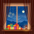 Christmas gifts on window with garlands, candle, lantern in cozy home on background of night blue mountains, snow Royalty Free Stock Photo