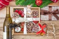 Christmas gifts in a wooden box on a wooden background. Christmas tree branches, decorations, cones, angel and gifts. Royalty Free Stock Photo