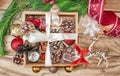Christmas gifts in a wooden box on a wooden background. Christmas tree branches, decorations, cones, angel and gifts Royalty Free Stock Photo