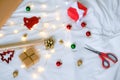 Christmas gifts wrapping, paper and accessories on white bed Royalty Free Stock Photo