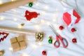 Christmas gifts wrapping, paper and accessories on white bed Royalty Free Stock Photo