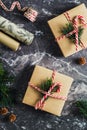 Christmas gifts, wrapping paper, ribbon and decorations on slate table top view. Flat lay Royalty Free Stock Photo