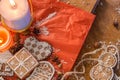 Christmas ginger cookies, candles and spices on a red and wooden background Royalty Free Stock Photo