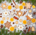 Christmas ginger cookies in the shape snowflakes, dried orange, star anise and snowman on gray stone background Royalty Free Stock Photo