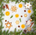 Christmas ginger cookies in the shape snowflakes, dried orange, star anise and snowman on gray stone background Royalty Free Stock Photo