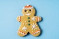 Christmas Gingerbread angel shape on blue background. Flat lay Royalty Free Stock Photo