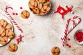 Christmas gingerbread background. Decorated red nosed reindeer cookies with chocolate buttons and melted chocolate.