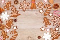 Christmas gingerbread cookies, candy and baking items, above view arched frame on a wood background Royalty Free Stock Photo