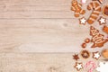 Christmas gingerbread cookies, candy and baking items, side border on a wood background Royalty Free Stock Photo