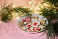 Christmas gingerbread cookies of different shapes on a sparkling lights background. Royalty Free Stock Photo