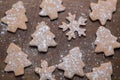 Christmas gingerbread cookies different shapes on wooden background as pattern. Homemade bakery making