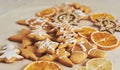 Christmas gingerbread cookies and dried orange and spices on white table Royalty Free Stock Photo