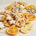 Christmas gingerbread cookies and dried orange and spices on white table Royalty Free Stock Photo