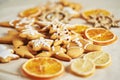 Christmas gingerbread cookies and dried orange and spices on white table Royalty Free Stock Photo